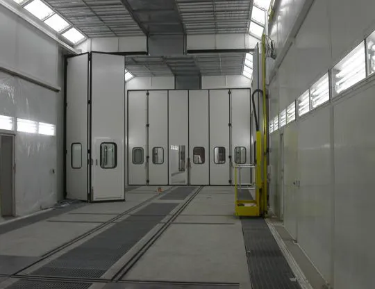 Four-stage pressurized painting-drying booth (10 + 10 + 10 + 10 meters) for a total length of 40 meters. Upper opening along its entire length for inserting pieces with overhead crane and rails for sliding piece-holder trolleys