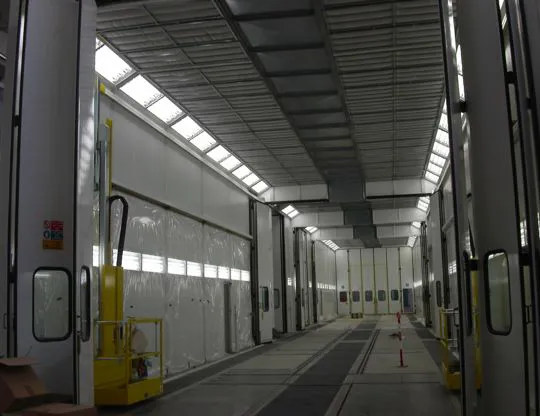 Four-stage pressurized painting-drying booth (10 + 10 + 10 + 10 meters) for a total length of 40 meters. Front and side openings and mobile platforms for operators