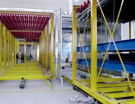 Motorized trolleys with rails for the synchronized insertion of 7,000 mm long hangers